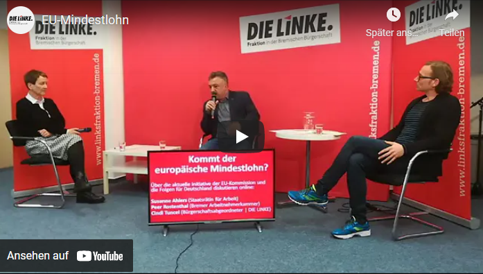 Drei Personen diskutieren; auf dem Hintergrund befindet sich der Schriftzug der Partei: Die Linke